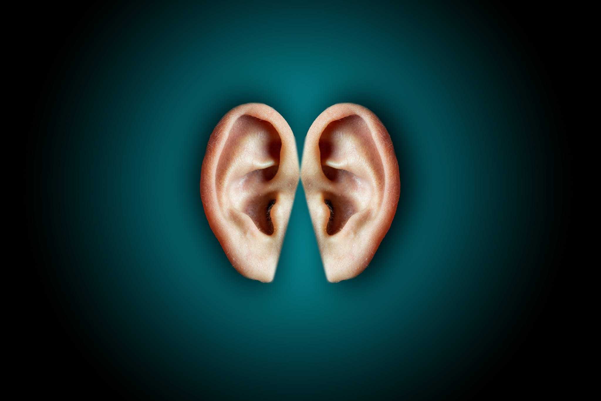 Creative shot of human ears on dark background