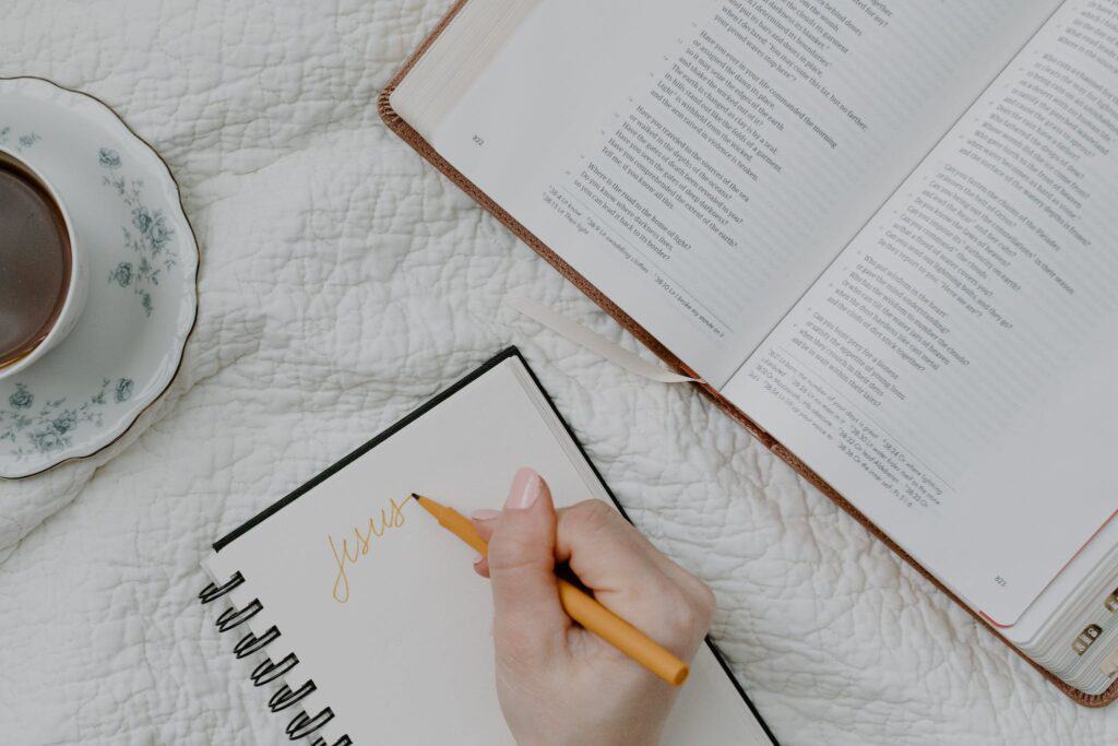 Person Writing on a Notebook