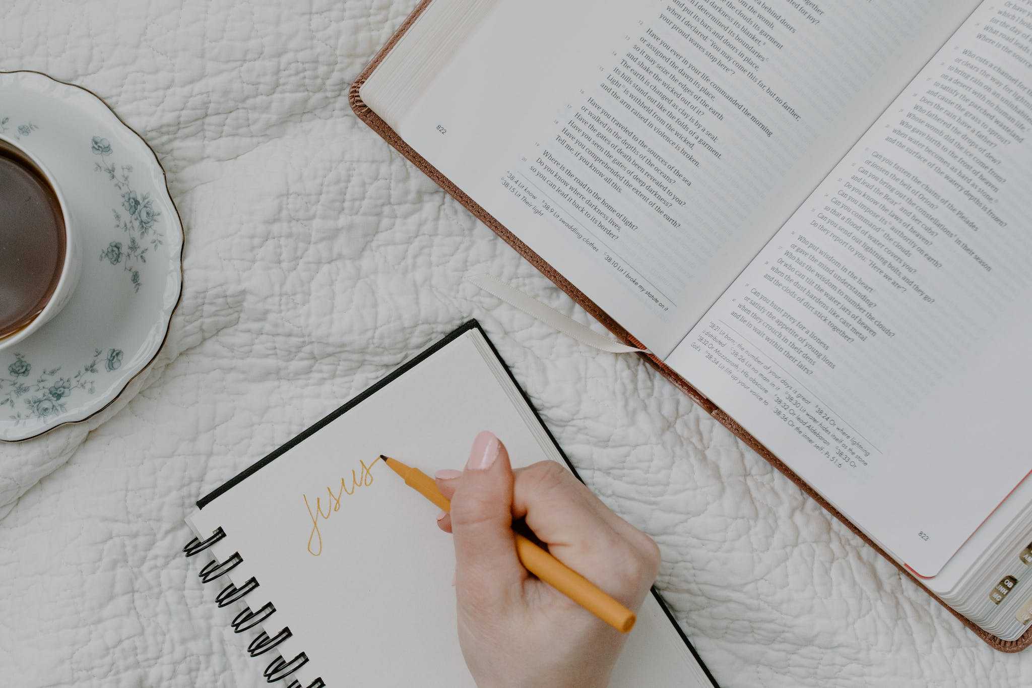 Person Writing on a Notebook