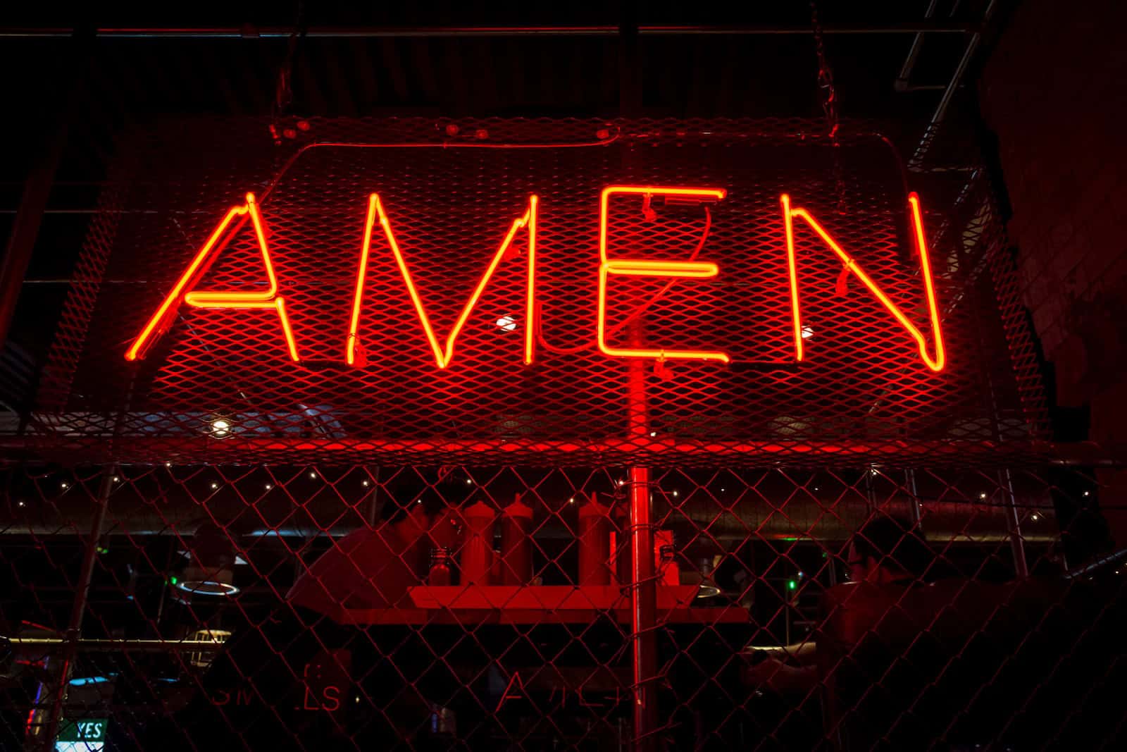 red Amen lit-up signage