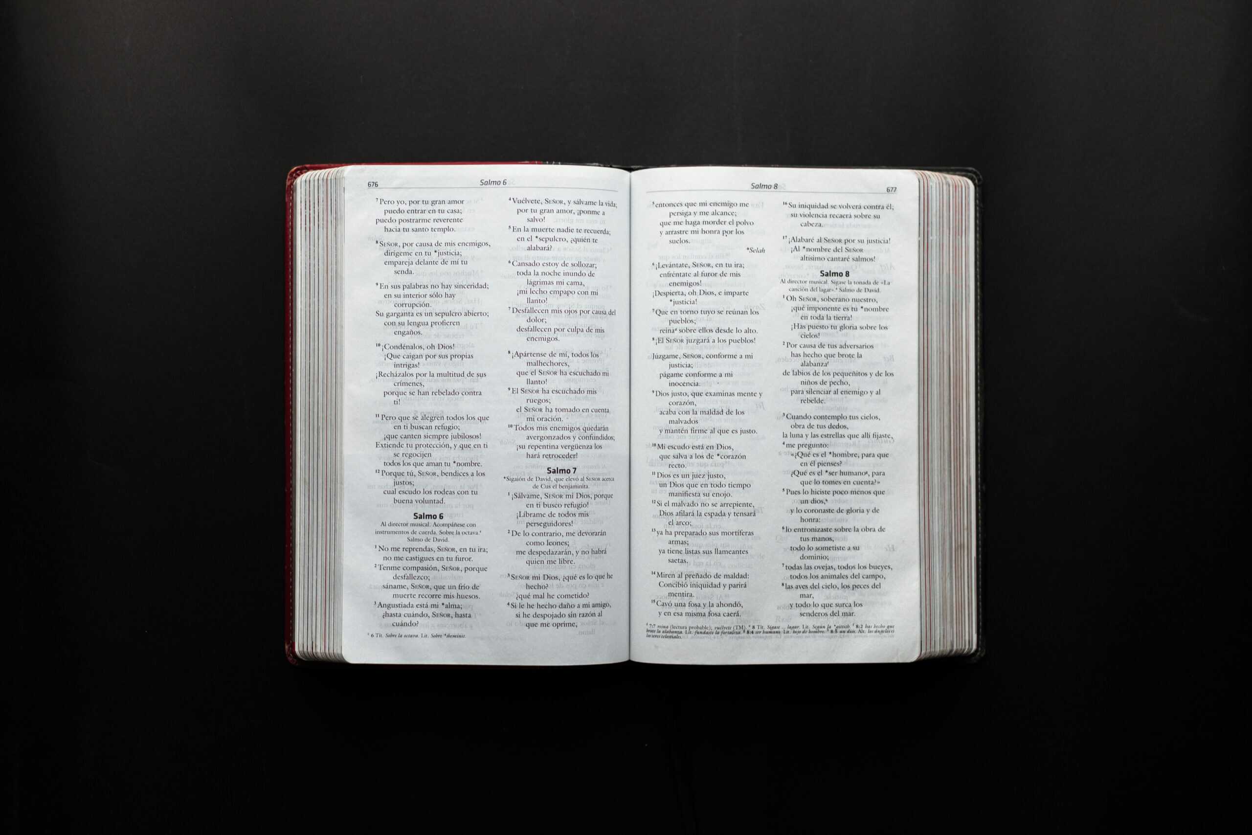 Open Bible displaying Psalms on a dark surface for study or inspiration.